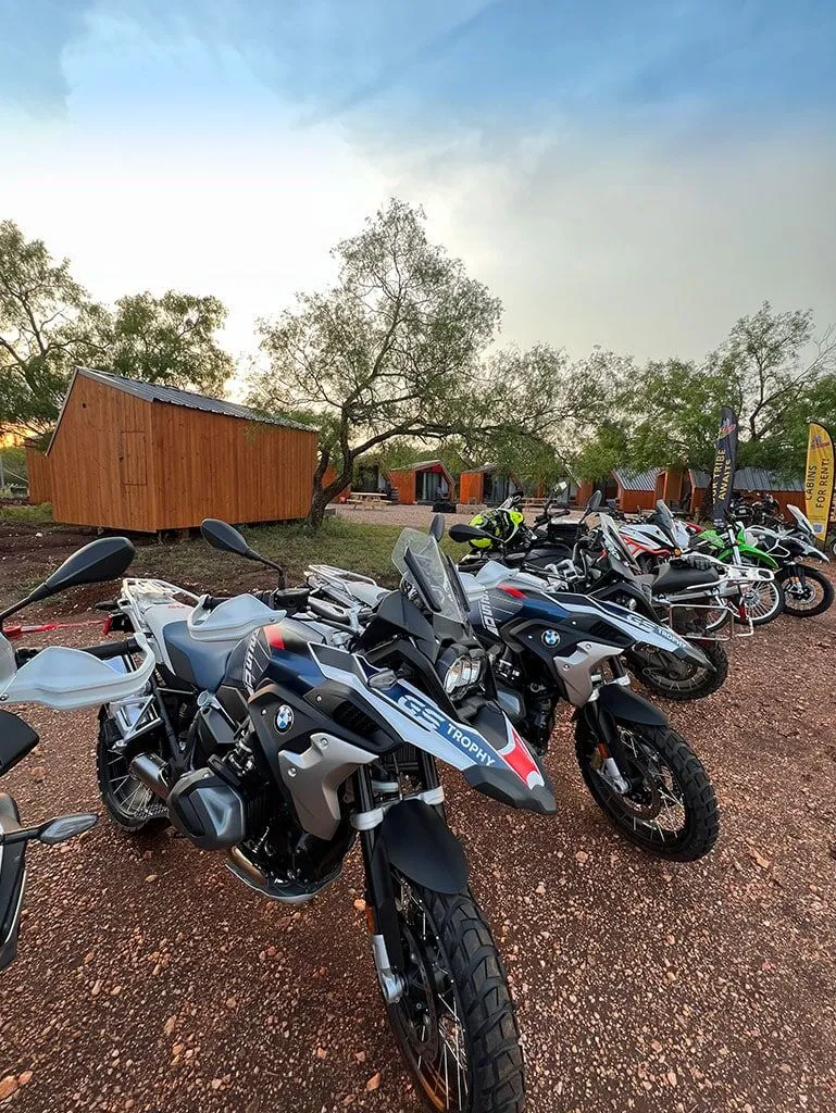 Motorcycles parked by cabins